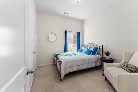 a bedroom with a bed and window