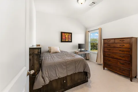 a bedroom with a bed and a dresser