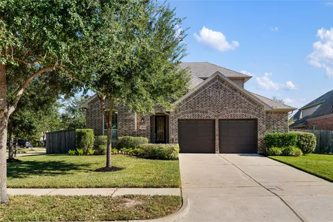 a front view of a house with a yard and a garage