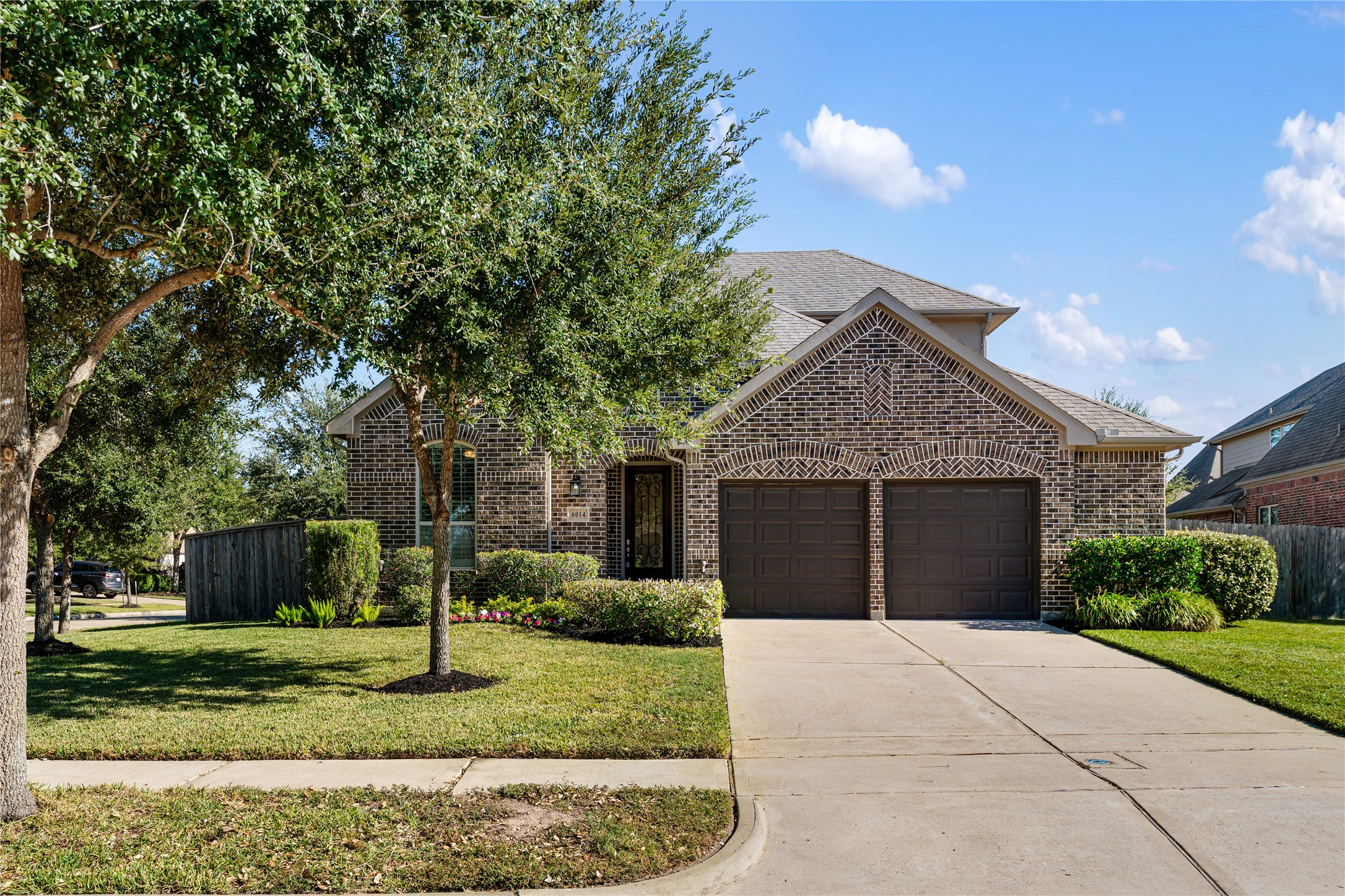6014 Barrett Cove Court Richmond, TX 77407 - Photo 4 of 45 a front view of a house with a yard and a garage