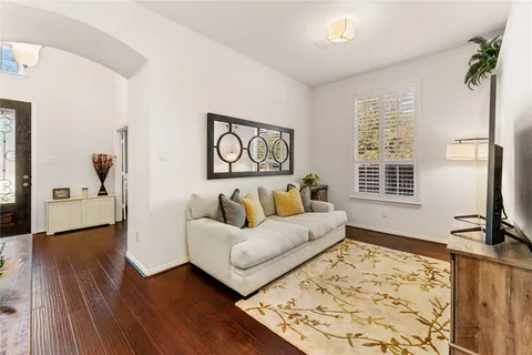 a living room with furniture and wooden floor