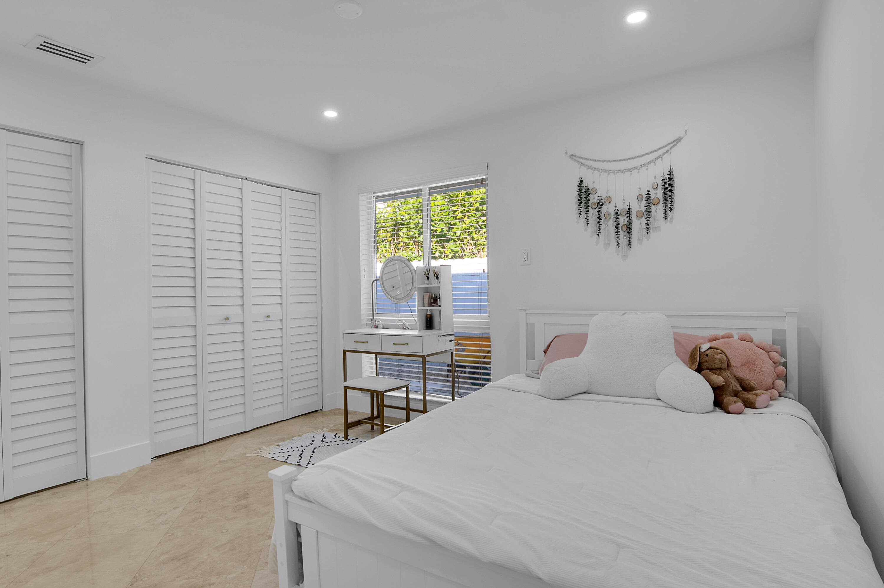 1499 Southwest 20th Street Boca Raton, FL 33486 - Photo 36 of 82 a bedroom with a bed and a table in it