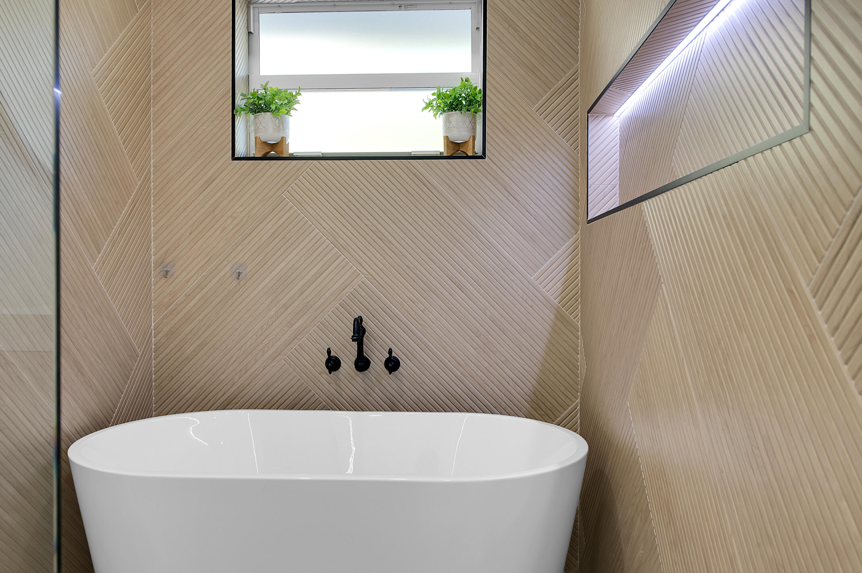 1499 Southwest 20th Street Boca Raton, FL 33486 - Photo 41 of 82 a white bath tub sitting in a bathroom next to a window