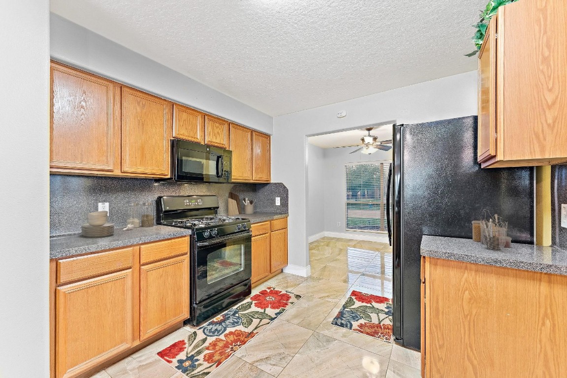 11622 Silent Elm Street Houston, TX 77044 - Photo 4 of 6 a kitchen with stainless steel appliances granite countertop a refrigerator sink and stove
