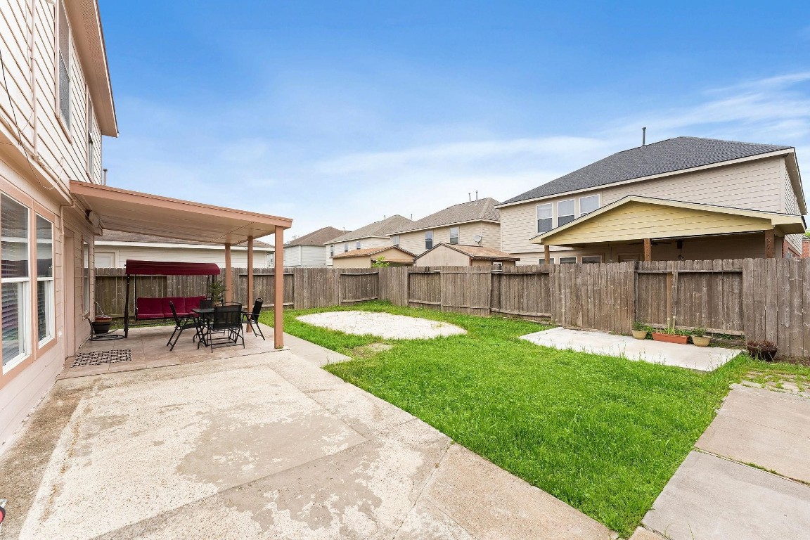 11622 Silent Elm Street Houston, TX 77044 - Photo 5 of 6 a view of a house with patio and a yard
