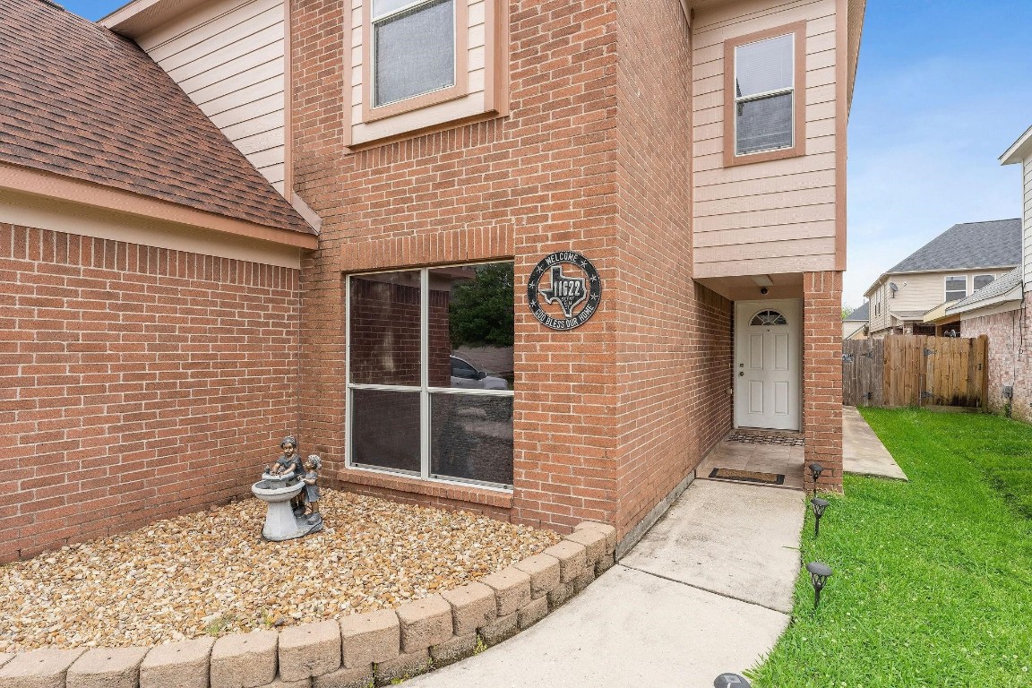 11622 Silent Elm Street Houston, TX 77044 - Photo 6 of 6 a front view of a house with garden