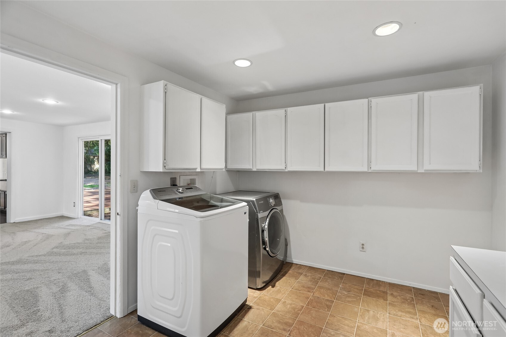 28601 Southeast 225th Street Maple Valley, WA 98038 - Photo 27 of 40 a view of a kitchen with a sink and a stove top oven