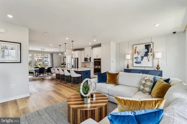 a living room with furniture and kitchen view