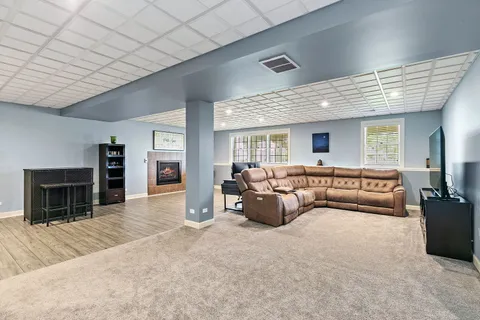 a living room with furniture and a fireplace