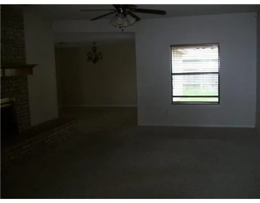 a view of a livingroom with an empty space and a window