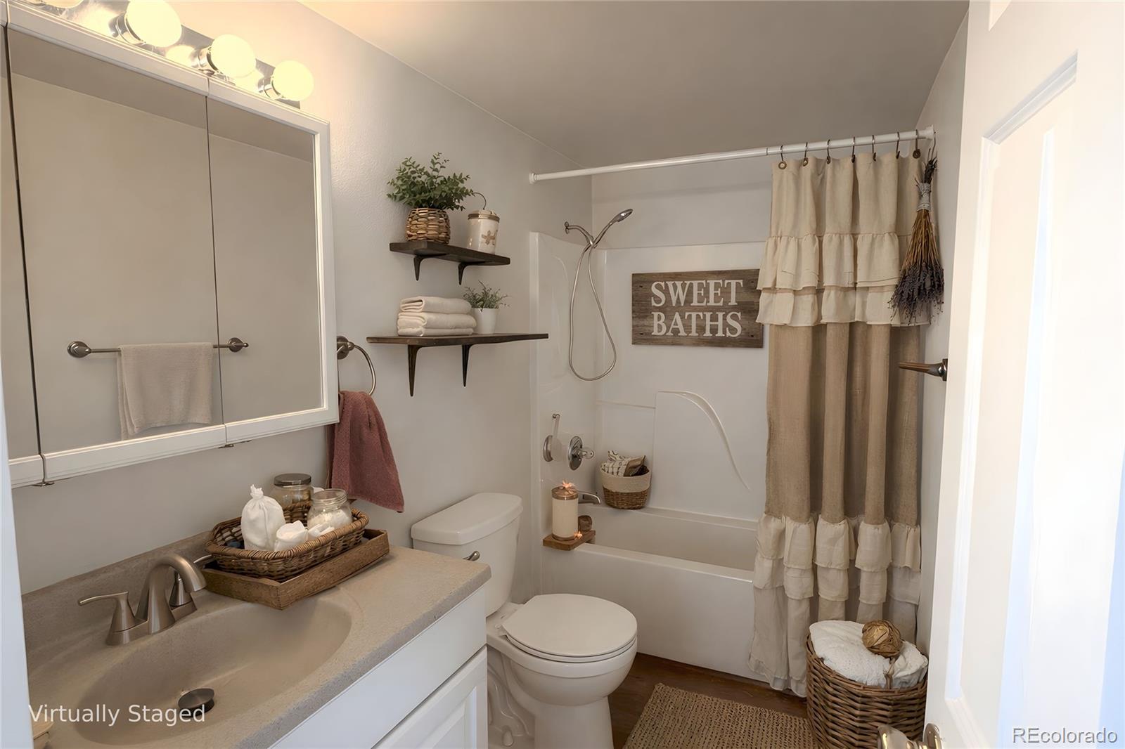 715 2nd Street Silver Cliff, CO 81252 - Photo 11 of 16 a bathroom with a toilet a sink and shower curtain