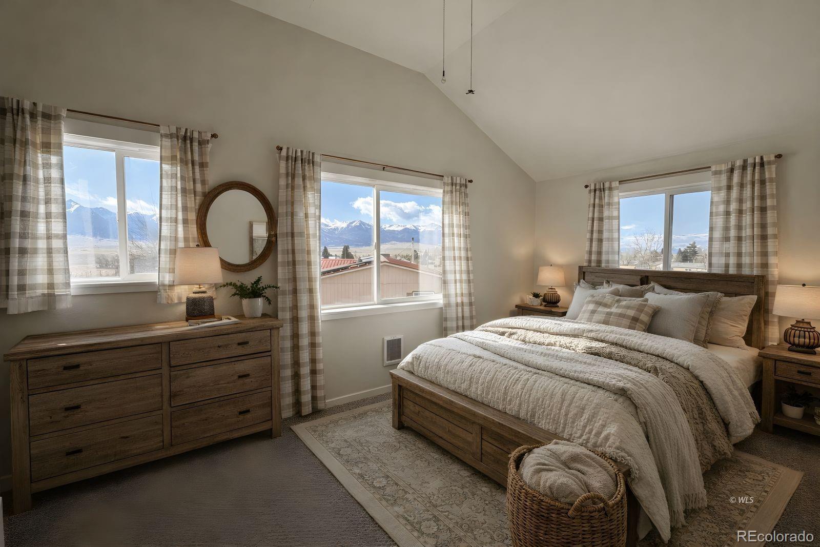 715 2nd Street Silver Cliff, CO 81252 - Photo 12 of 16 a bedroom with a large bed and a large window