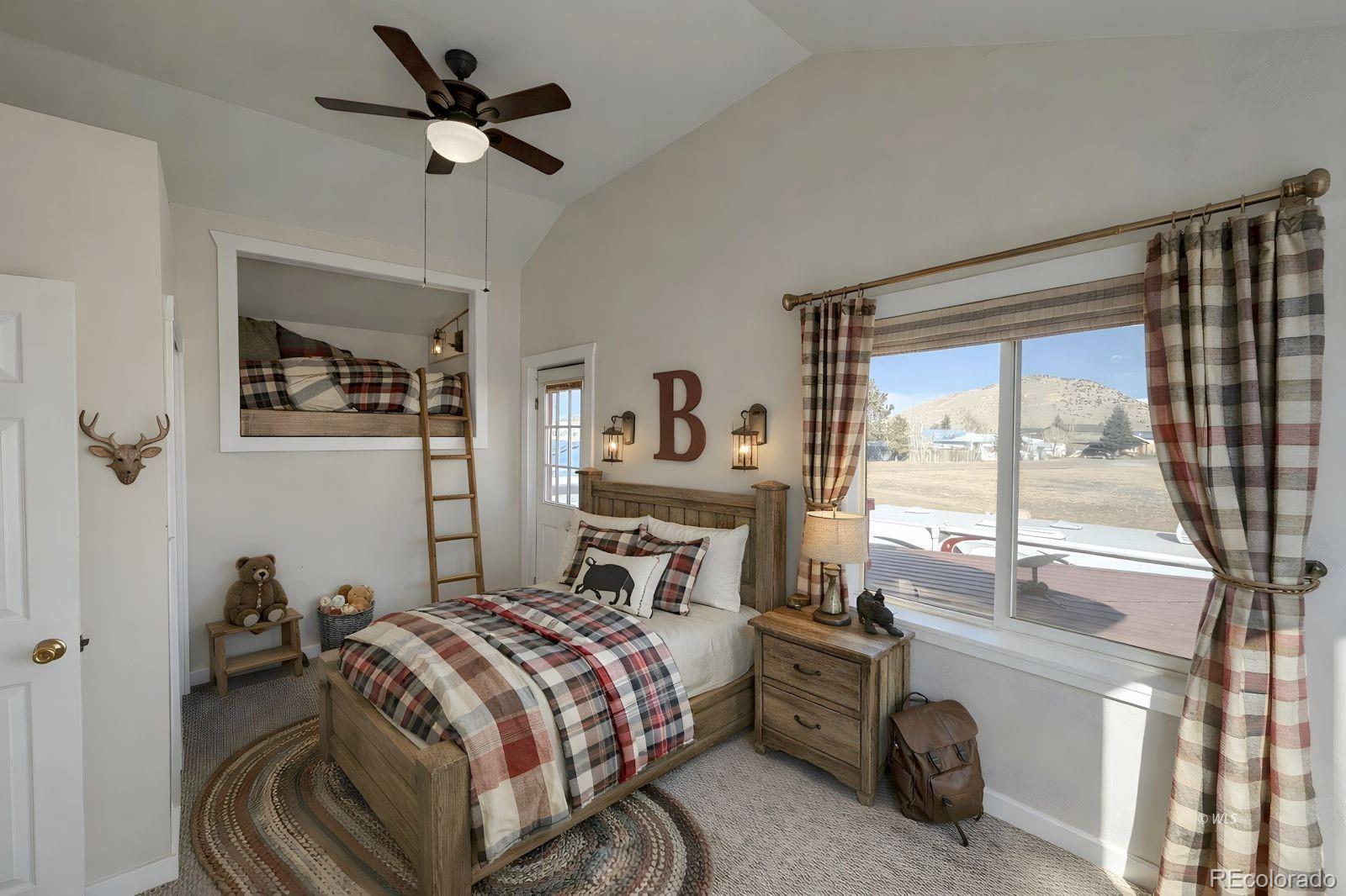 715 2nd Street Silver Cliff, CO 81252 - Photo 13 of 16 a bedroom with a balcony a bed and a large window