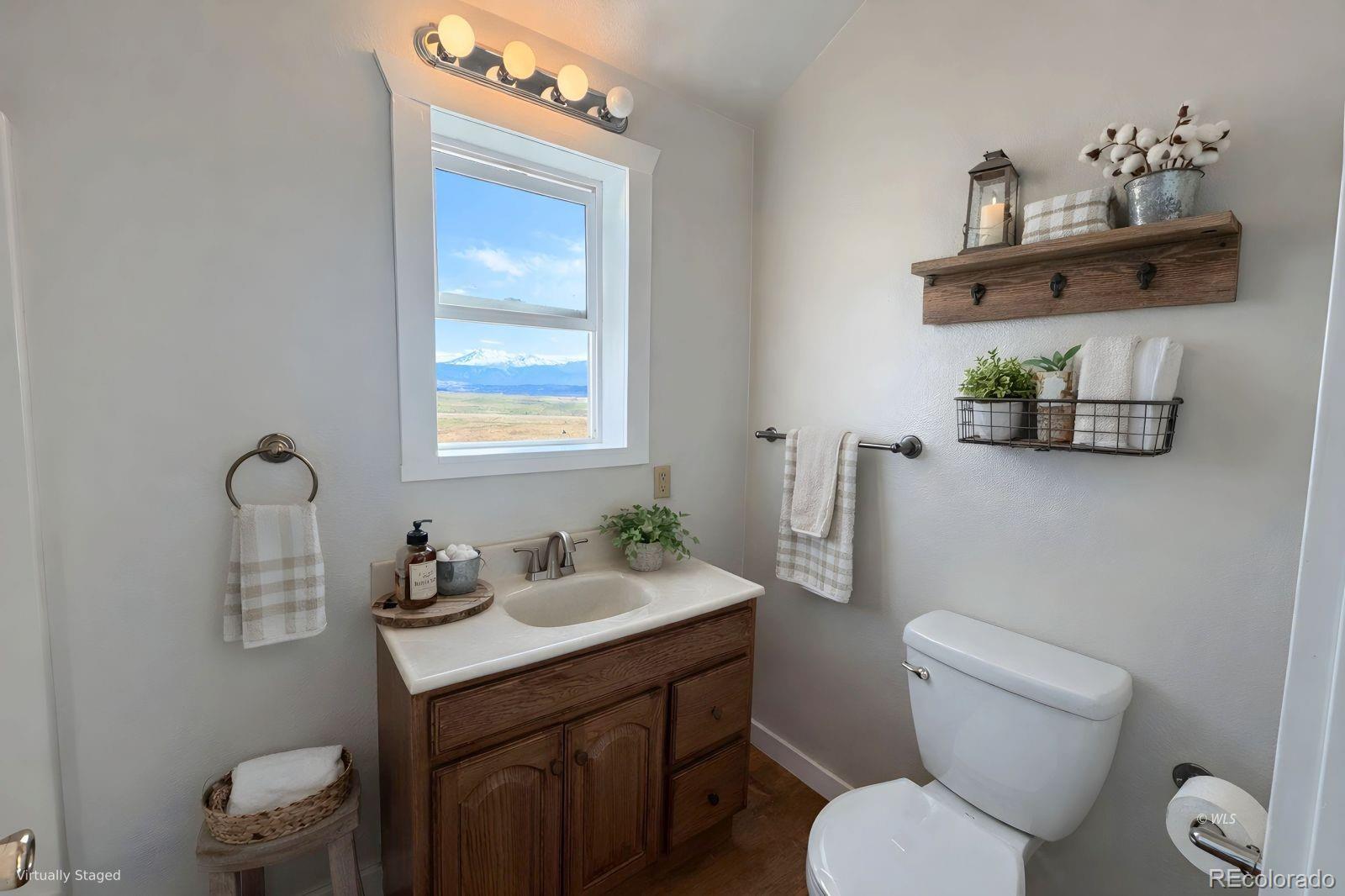 715 2nd Street Silver Cliff, CO 81252 - Photo 14 of 16 a bathroom with a toilet sink and mirror