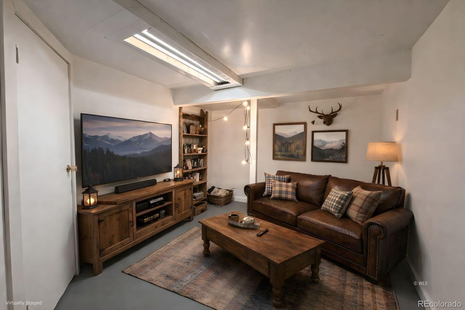 715 2nd Street Silver Cliff, CO 81252 - Photo 16 of 16 a living room with furniture and a flat screen tv