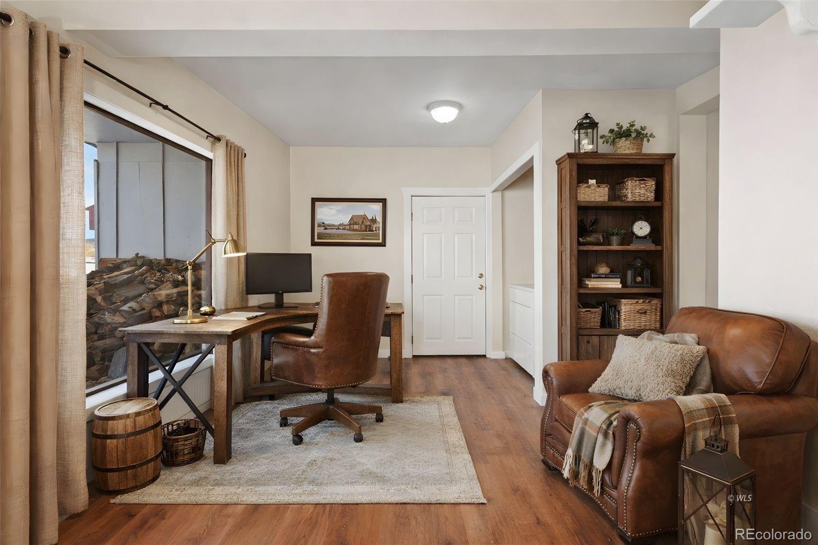 715 2nd Street Silver Cliff, CO 81252 - Photo 6 of 16 a livingroom with workspace and a couch