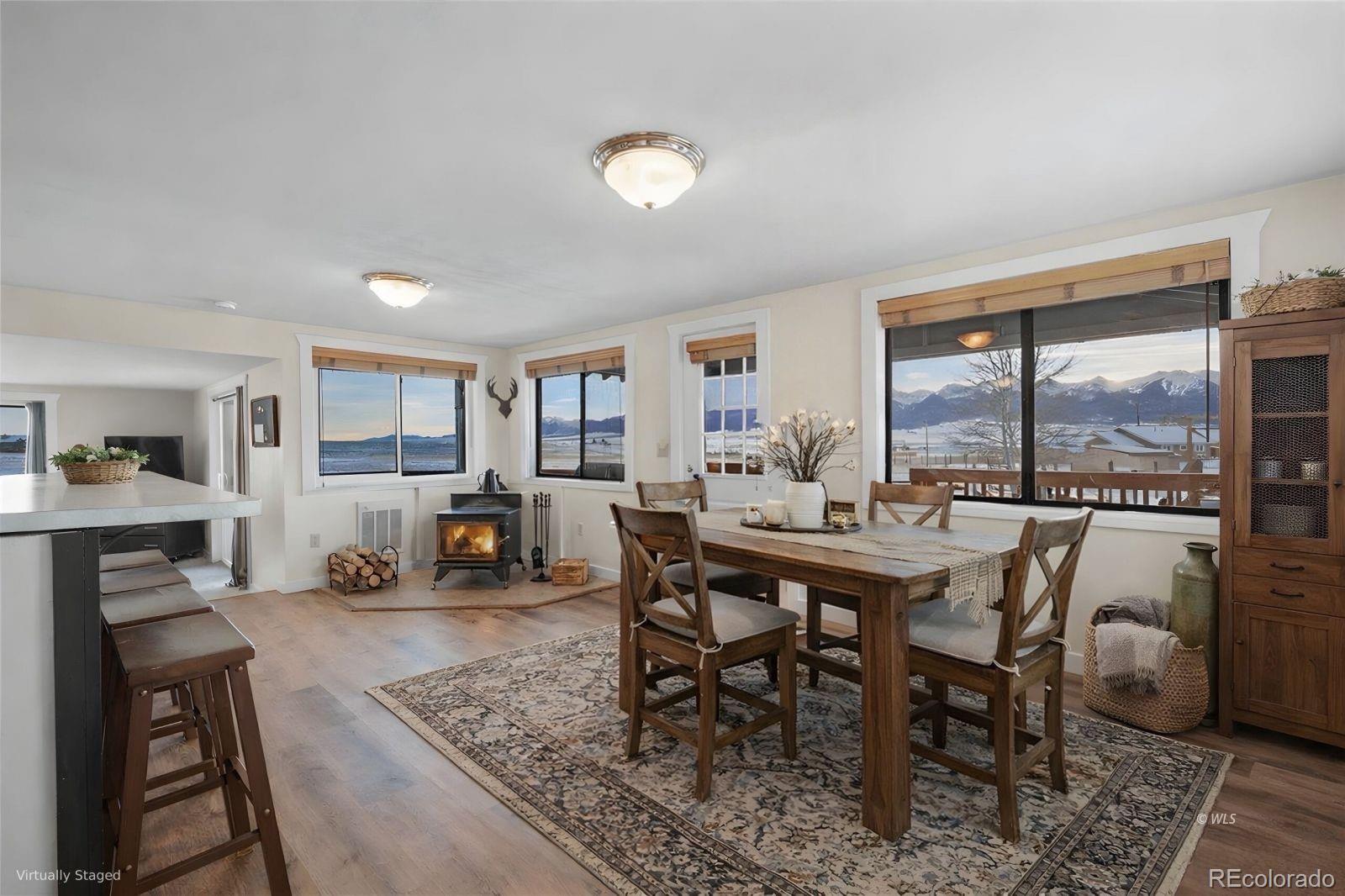 715 2nd Street Silver Cliff, CO 81252 - Photo 9 of 16 a dining room with furniture and a floor to ceiling window