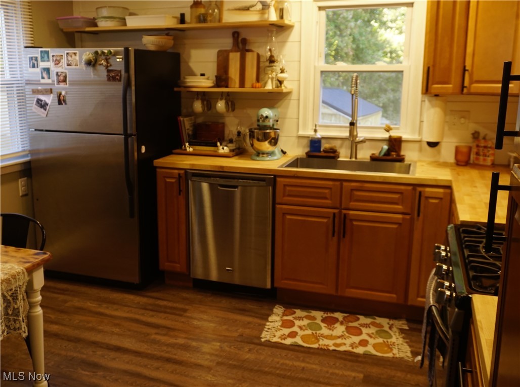 236 South Hickin Street Rittman, OH 44270 - Photo 13 of 27 Kitchen featuring dark wood-type flooring, stainless steel appliances, and sink