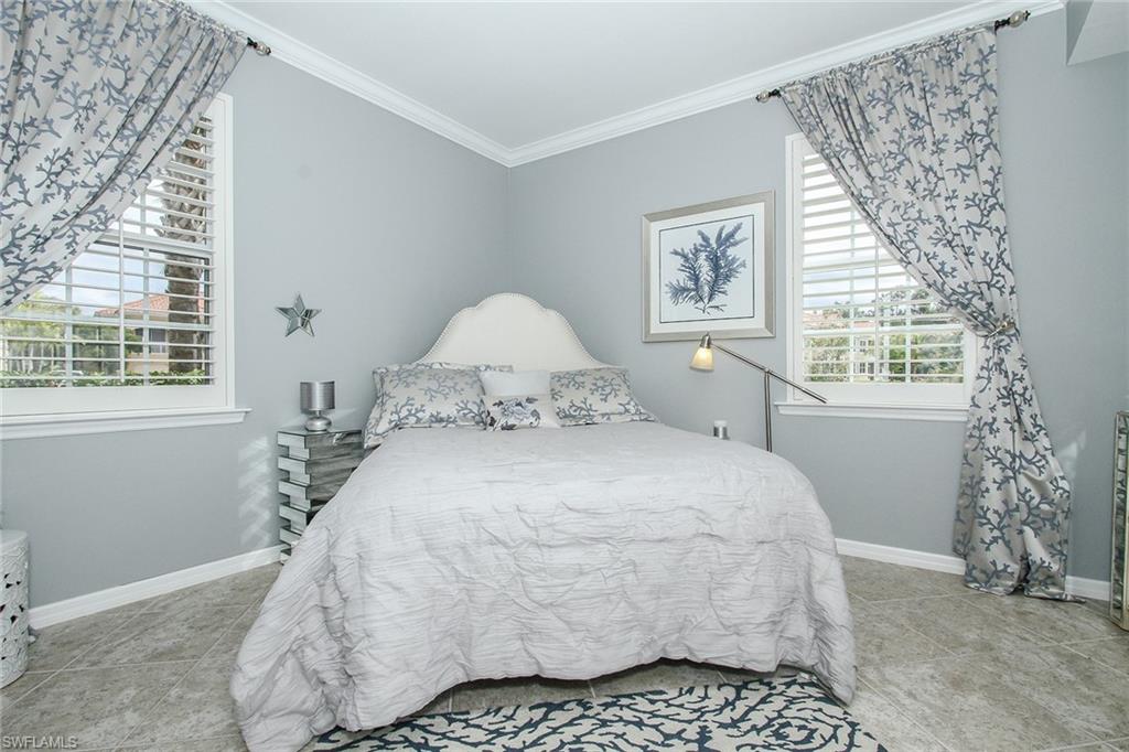 8531 Violeta Street, Unit 101 Estero, FL 34135 - Photo 12 of 23 a bedroom with a bed and a window