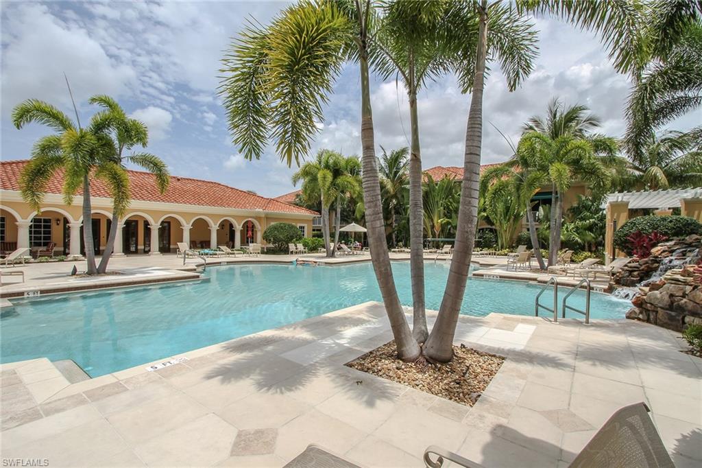 8531 Violeta Street, Unit 101 Estero, FL 34135 - Photo 19 of 23 a view of a swimming pool with a garden and plants