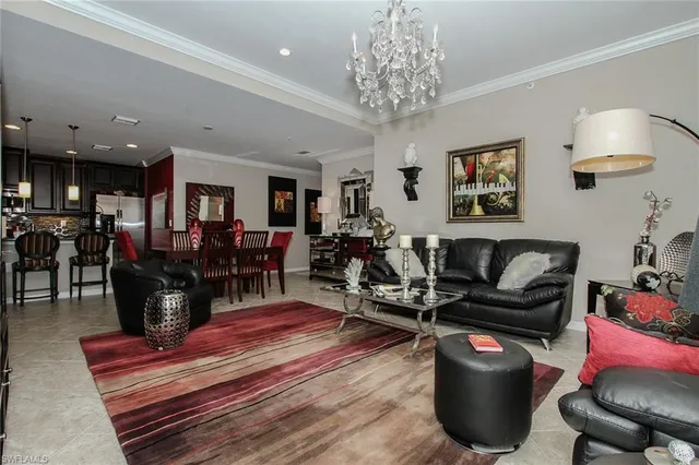 a living room with furniture a chandelier and a piano