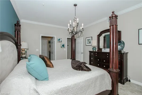 a bedroom with a bed dresser and a flat tv screen