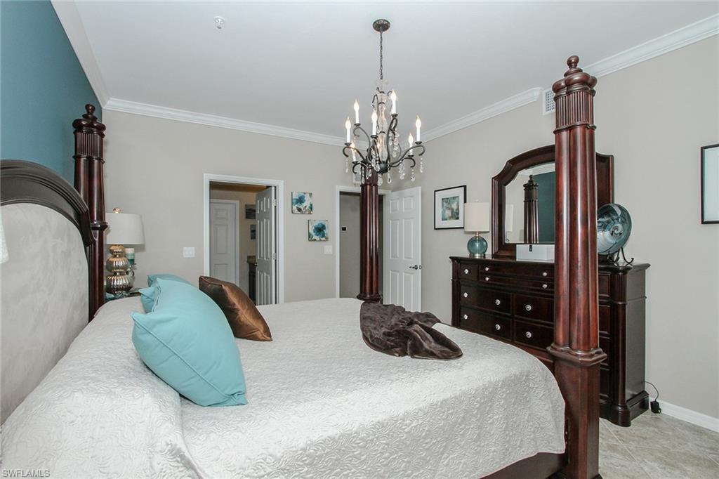 8531 Violeta Street, Unit 101 Estero, FL 34135 - Photo 10 of 23 a bedroom with a bed dresser and a flat tv screen