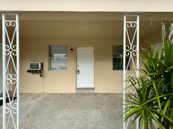 a view of a hall with wooden floor and stairs