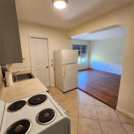 a kitchen with a stove and a refrigerator