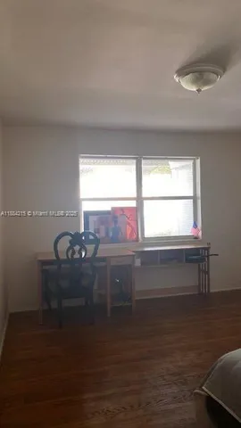 a view of lot of window and wooden floor