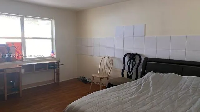 a bedroom with bed and a window