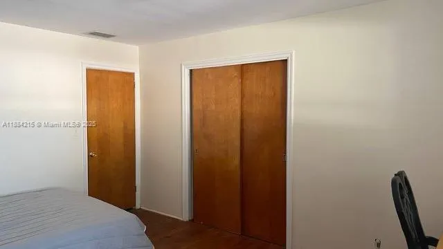 a bedroom with a wooden door