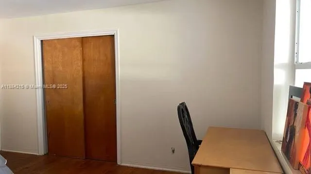 a view of a hallway with furniture and a window