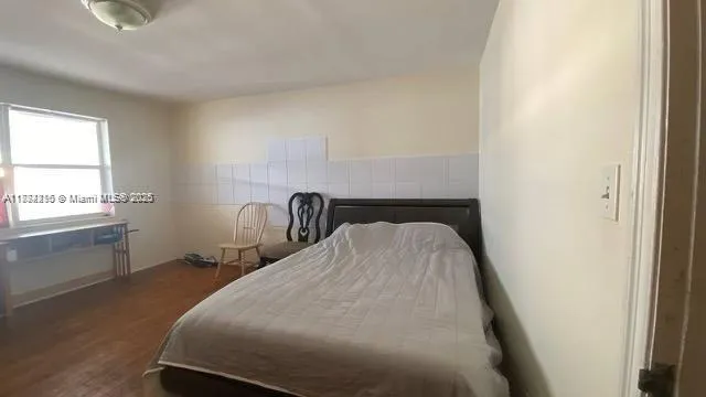 a bed room with a bed and a window