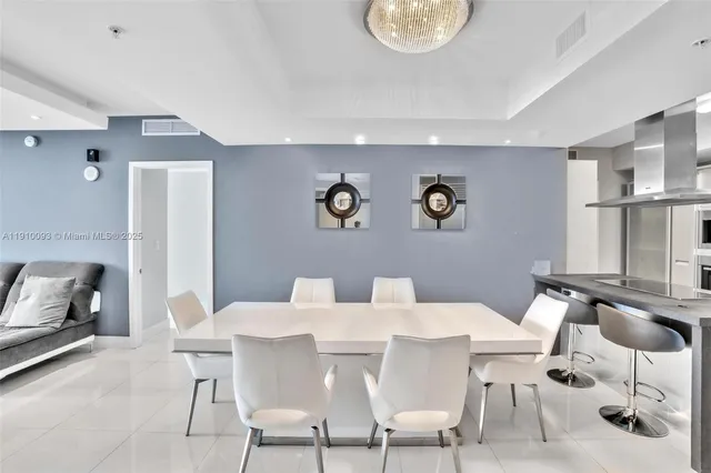 a view of a dining room with furniture and a potted plant