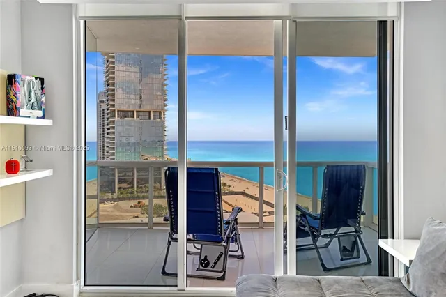 a view of a room with wooden floor and windows