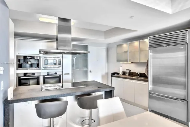 a spacious bedroom with a large bed and a large window