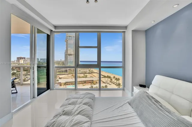 a living room with furniture and large windows