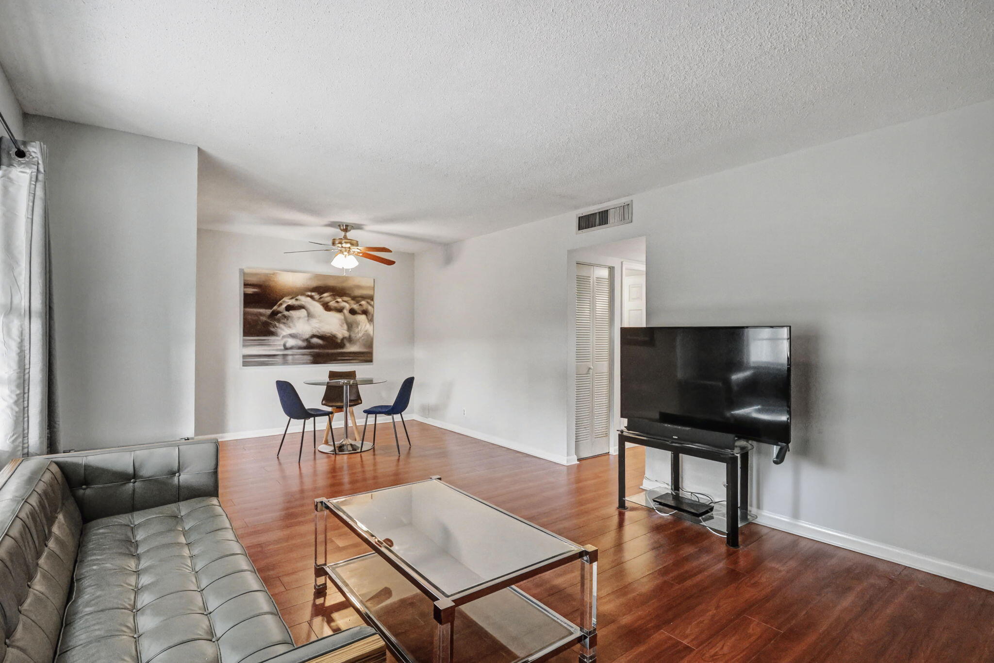 100 Royal Palm Way, Unit 303 Boca Raton, FL 33432 - Photo 15 of 35 a living room with furniture and a flat screen tv