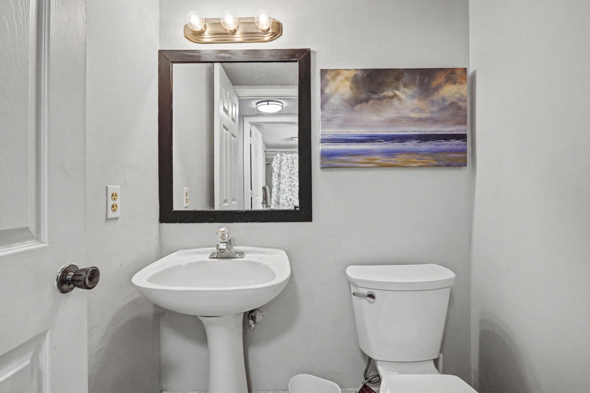 100 Royal Palm Way, Unit 303 Boca Raton, FL 33432 - Photo 16 of 35 a bathroom with a toilet a sink and mirror