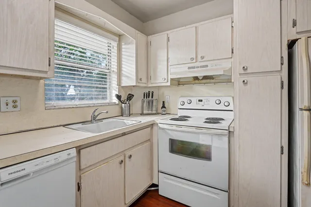 a kitchen with appliances cabinets and a sink