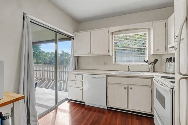 a kitchen with a sink window and cabinets