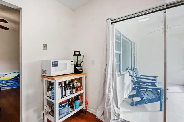 a living room with furniture wooden floor and a flat screen tv
