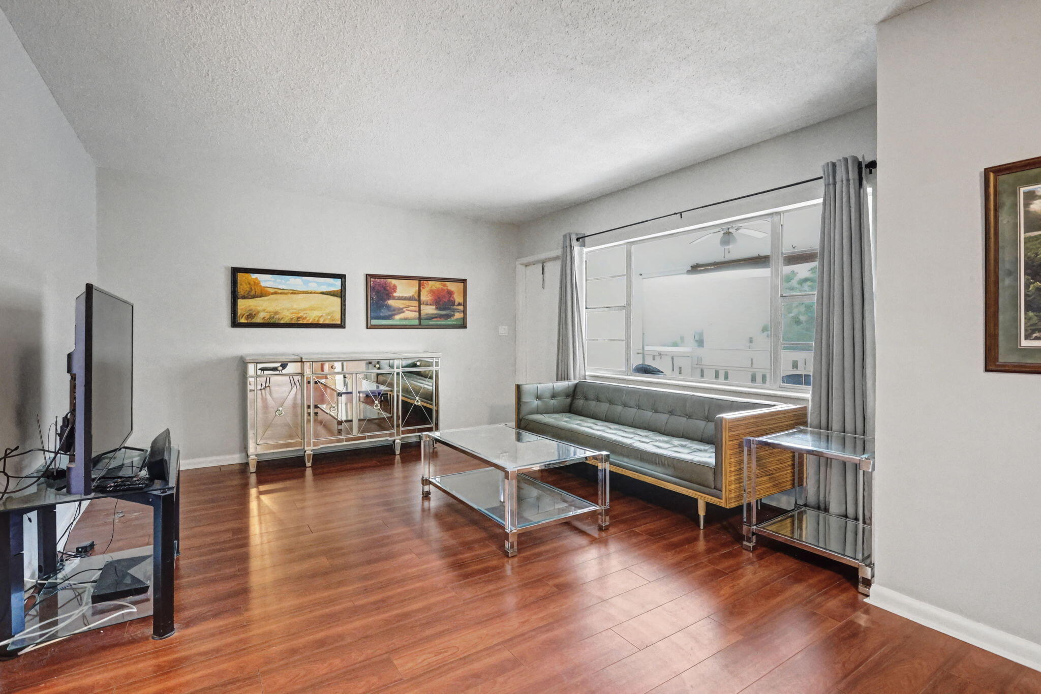 100 Royal Palm Way, Unit 303 Boca Raton, FL 33432 - Photo 10 of 35 a living room with furniture wooden floor and a flat screen tv