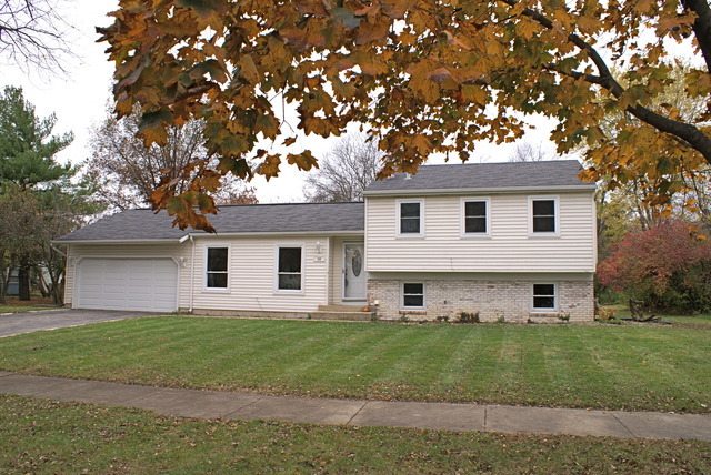 108 Cedarbrook Road Naperville, IL 60565 - Photo 1 of 1 a front view of a house with a garden