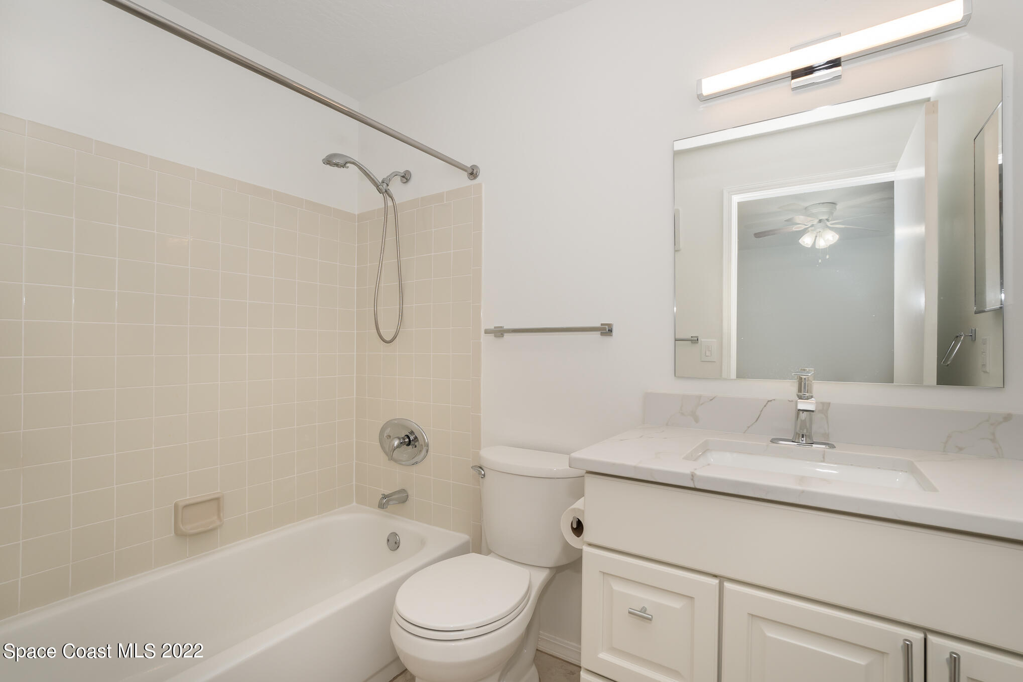 7667 North Wickham Road, Unit 113 Melbourne, FL 32940 - Photo 19 of 29 a bathroom with a granite countertop sink a toilet and shower