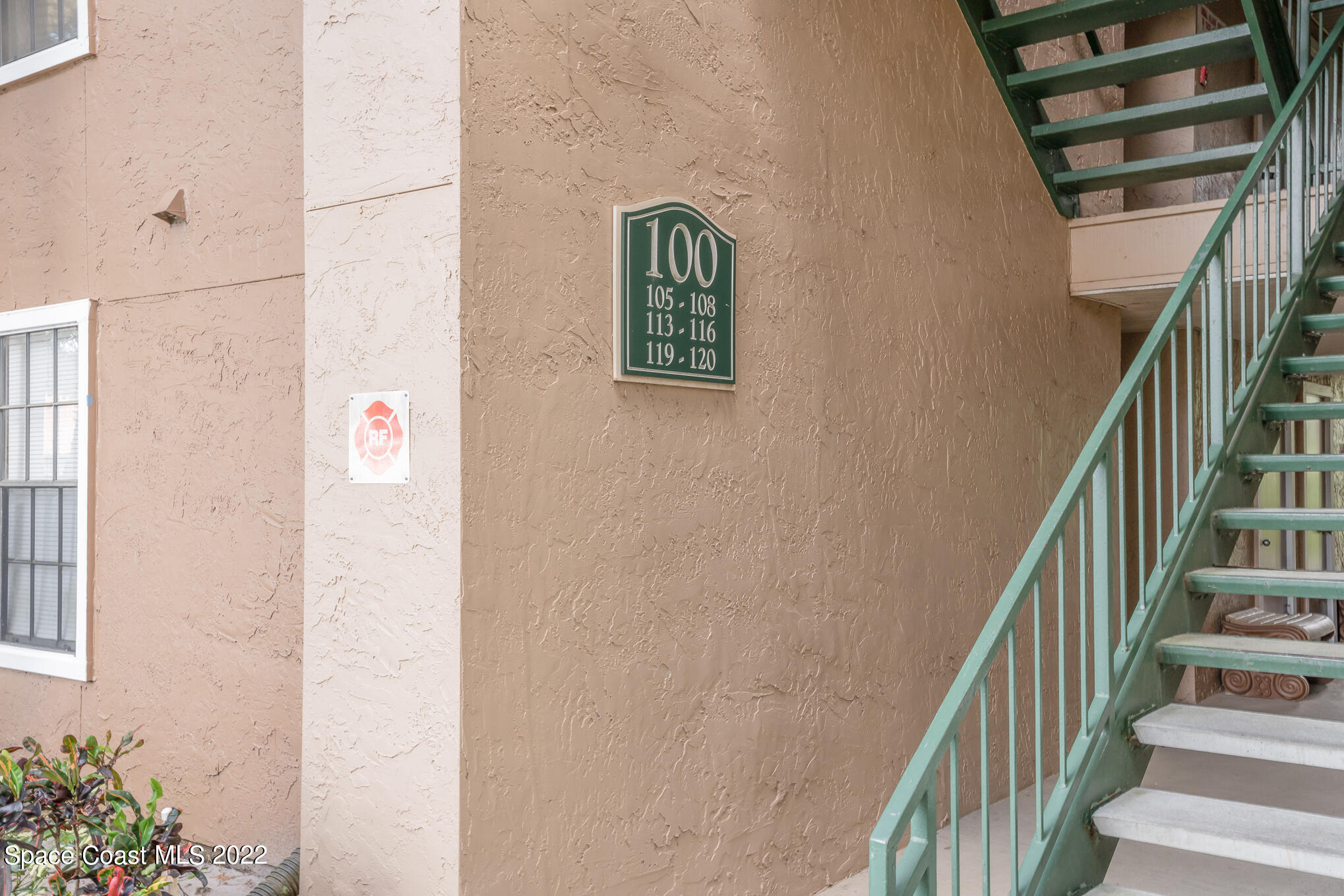 7667 North Wickham Road, Unit 113 Melbourne, FL 32940 - Photo 23 of 29 a view of staircase with wooden floor and lots of frames on wall
