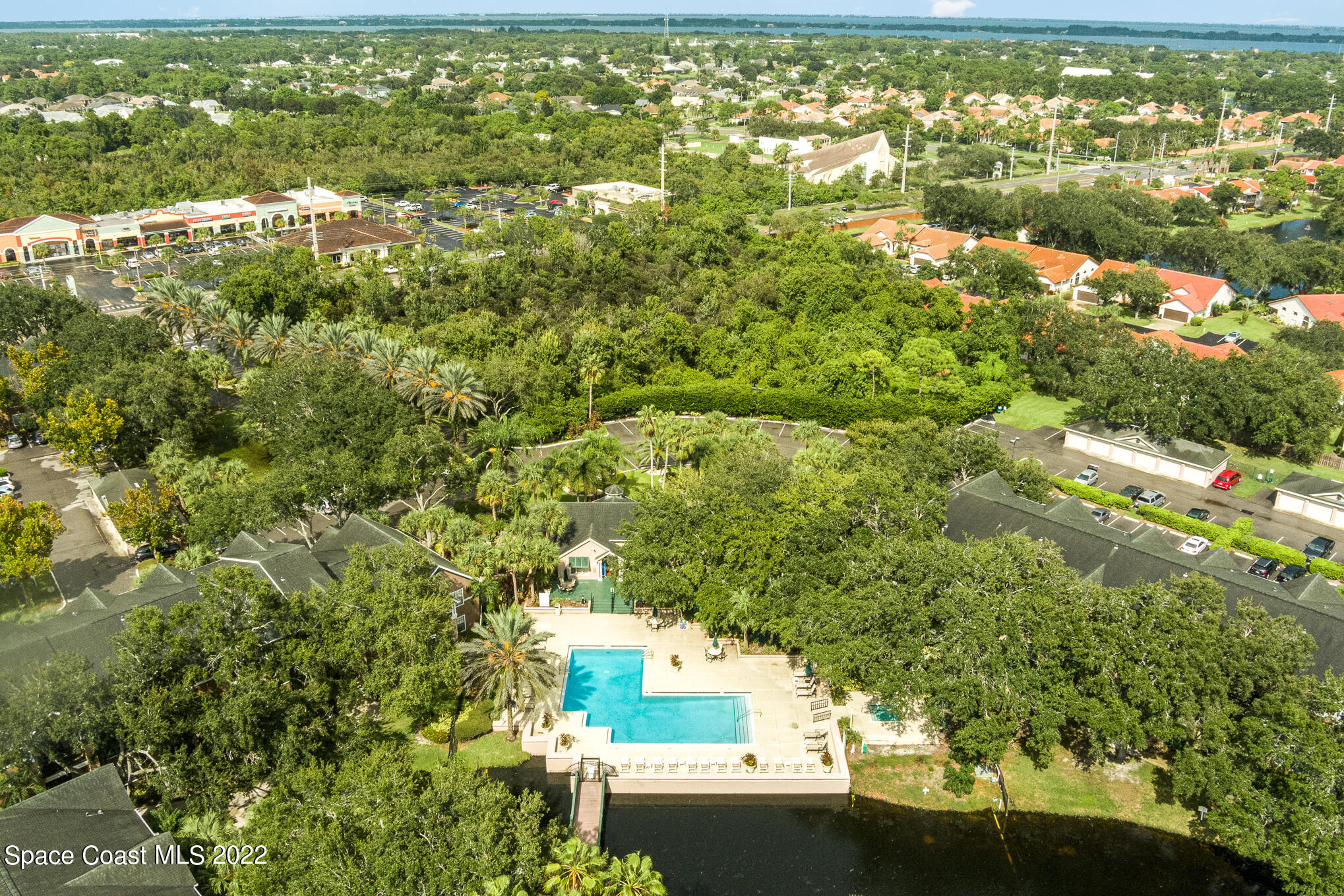 7667 North Wickham Road, Unit 113 Melbourne, FL 32940 - Photo 25 of 29 an aerial view of residential houses with outdoor space and trees