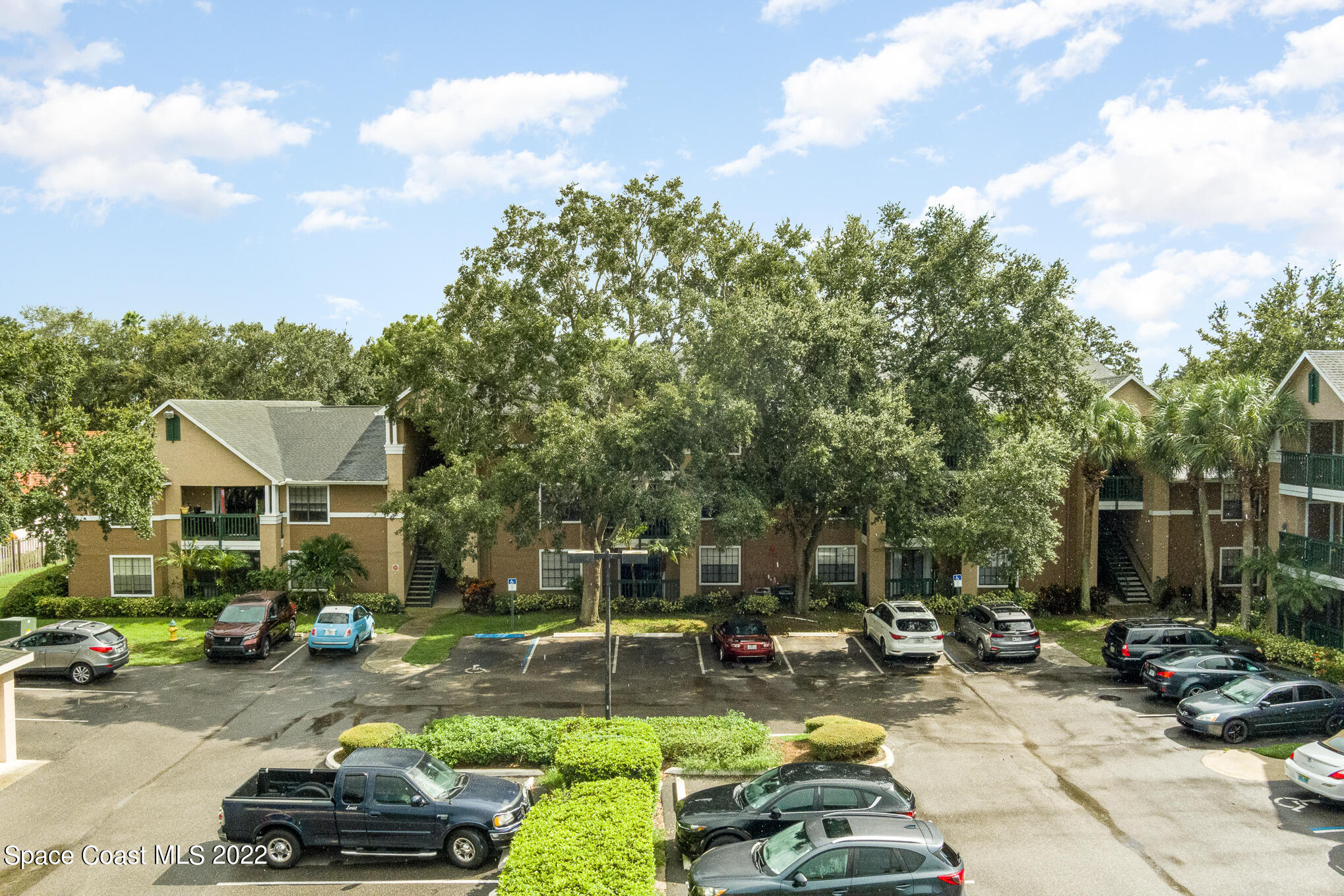 7667 North Wickham Road, Unit 113 Melbourne, FL 32940 - Photo 26 of 29 a car parked in front of a house