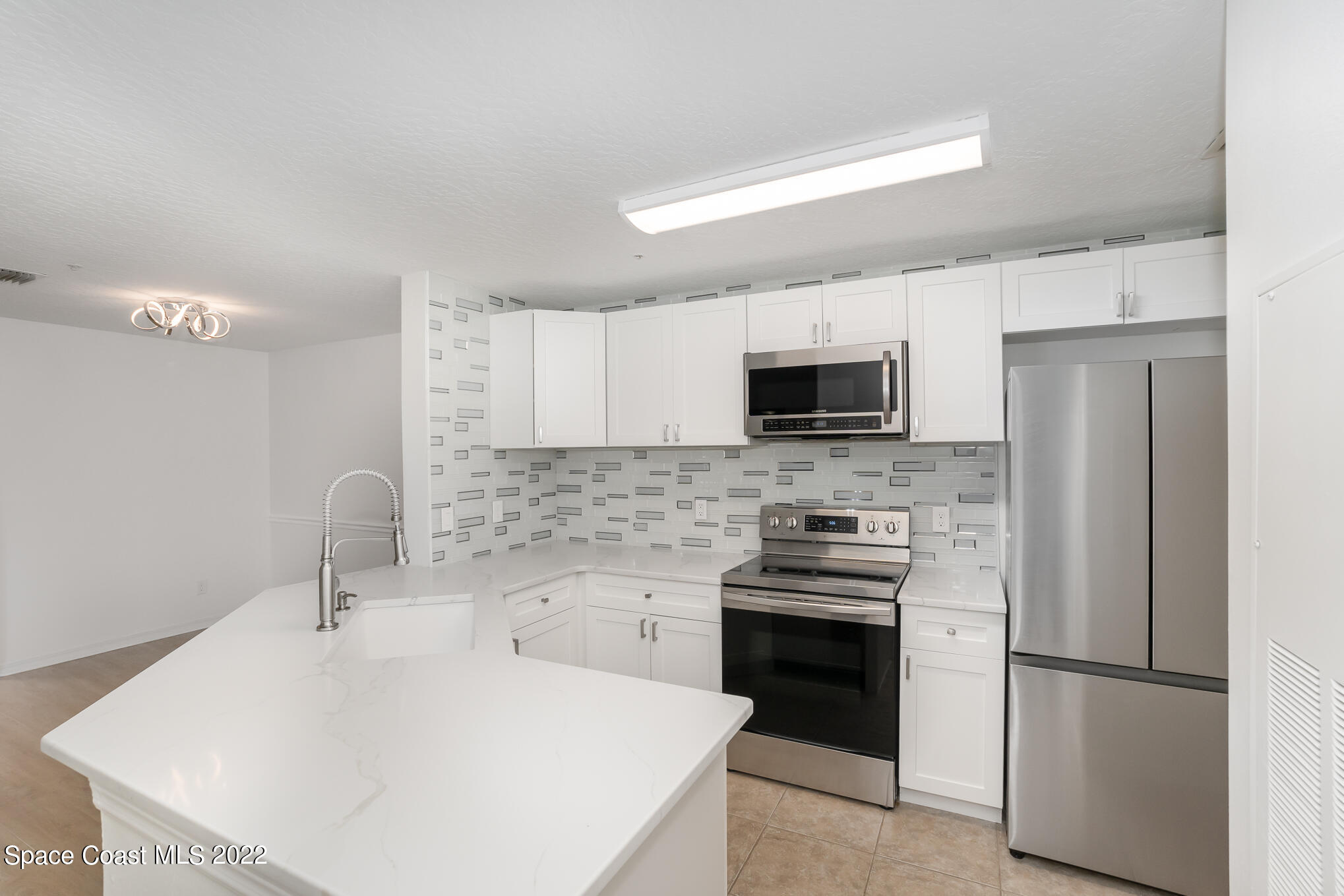 7667 North Wickham Road, Unit 113 Melbourne, FL 32940 - Photo 3 of 29 a kitchen with a sink appliances and cabinets